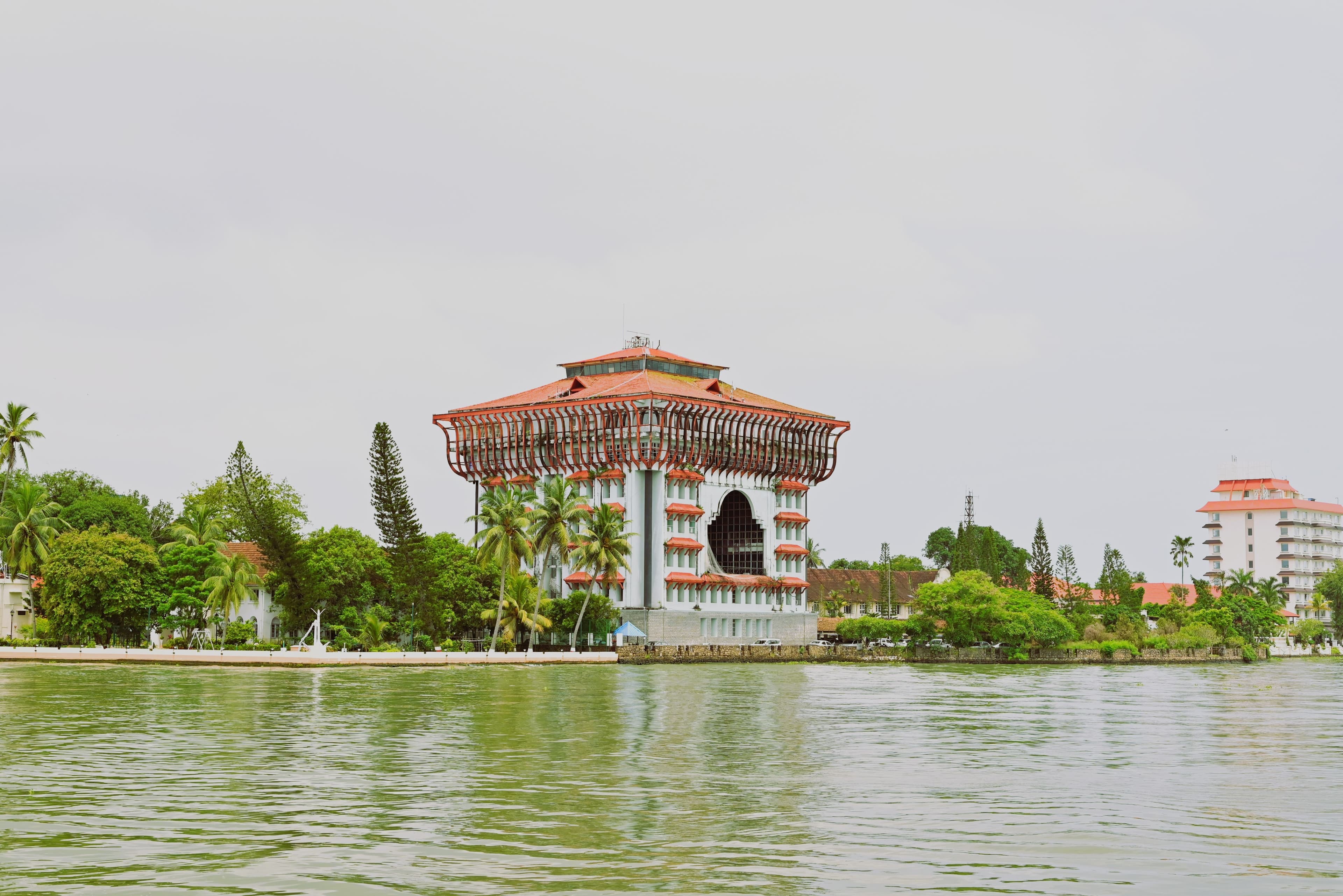 Stunning view of a landmark building in Kochi, Kerala, by a serene waterway.